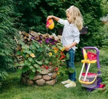 A Young Girl Watering a Plants