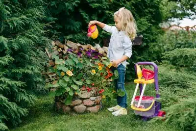 A Young Girl Watering a Plants