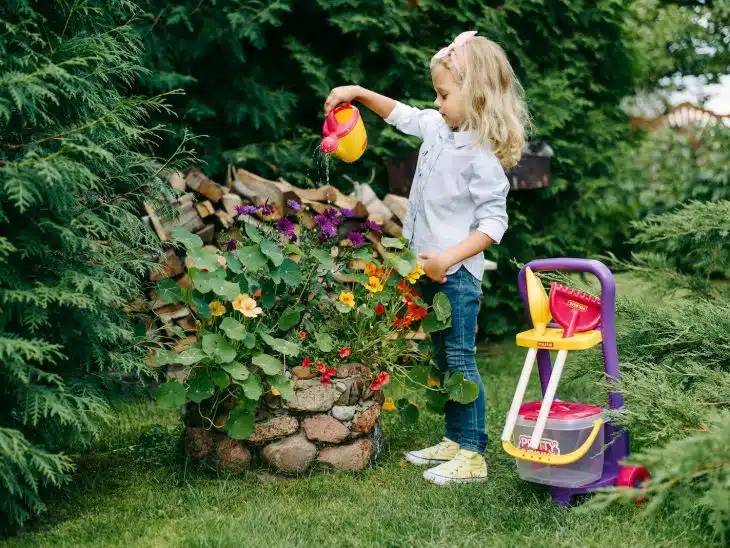 A Young Girl Watering a Plants